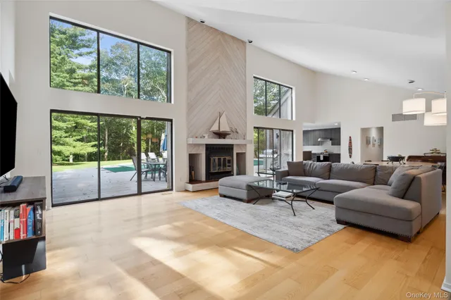 a living room with furniture large window and a flat screen tv