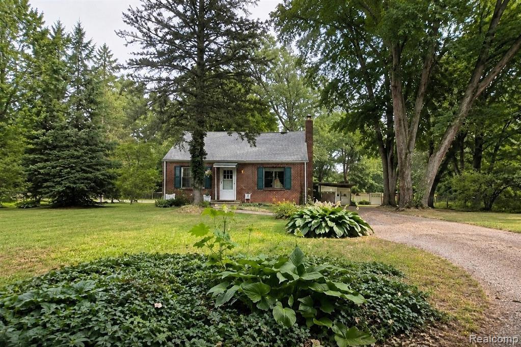 9552 Wayne Road Livonia, MI 48150 - Photo 1 of 31 Brick exterior residence featuring a front entry, green shutters, and a prominent chimney