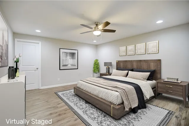 a bedroom with a large bed and a chandelier