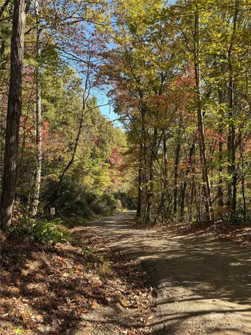 a view of dirt yard with a building