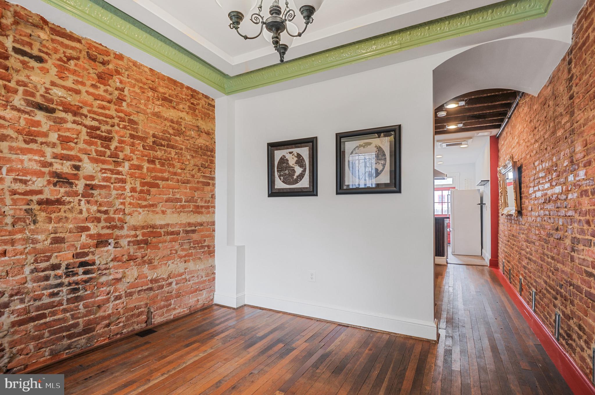 1112 3rd Street Northeast Washington, DC 20002 - Photo 6 of 16 a view of a hallway with wooden floor and chandelier