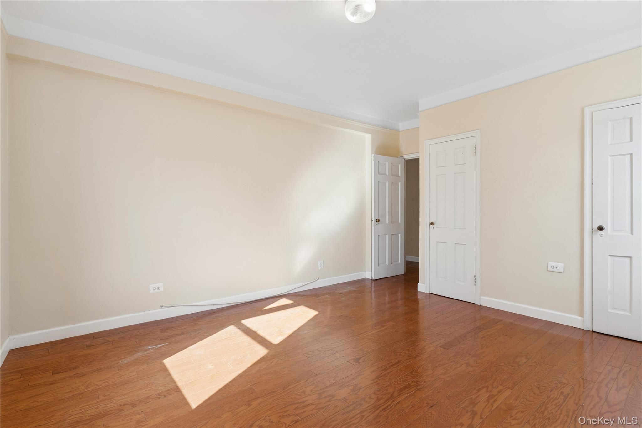 110-31 73rd Road, Unit 5N Queens, NY 11375 - Photo 9 of 13 Unfurnished bedroom featuring wood finished floors