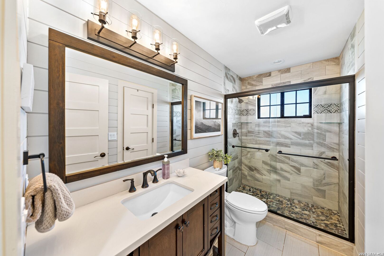 313 James Street Boerne, TX 78006 - Photo 15 of 27 a bathroom with a sink a toilet and shower