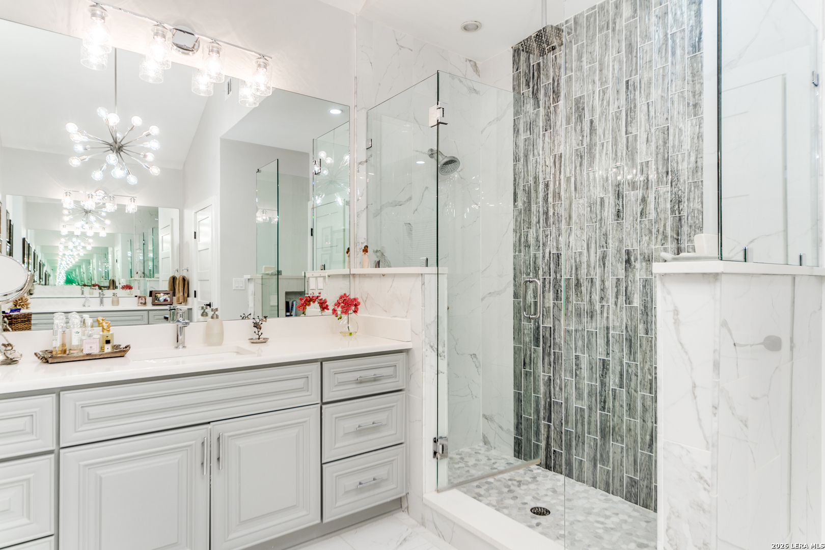 313 James Street Boerne, TX 78006 - Photo 18 of 27 a bathroom with a sink vanity granite shower and a mirror
