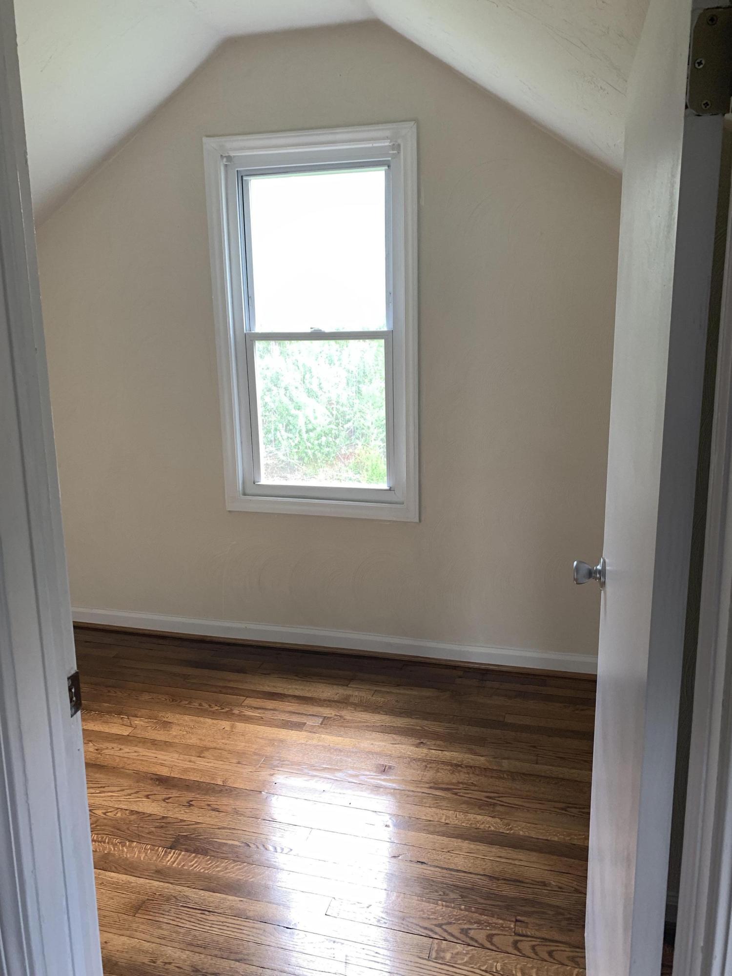 85 Old Ferrum Road Ferrum, VA 24088 - Photo 25 of 60 a view of an empty room with wooden floor and a window