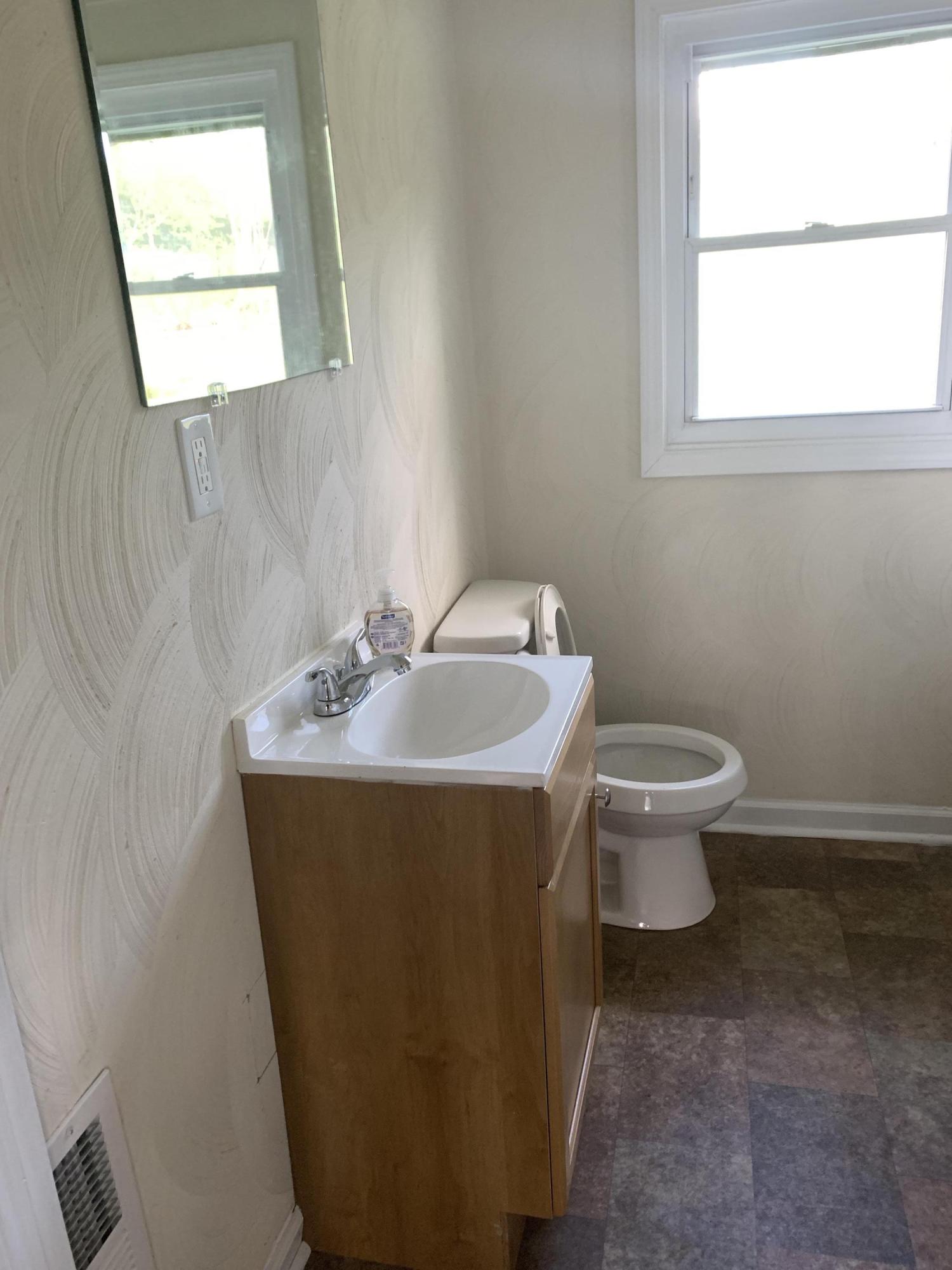 85 Old Ferrum Road Ferrum, VA 24088 - Photo 32 of 60 a bathroom with a sink toilet and a window