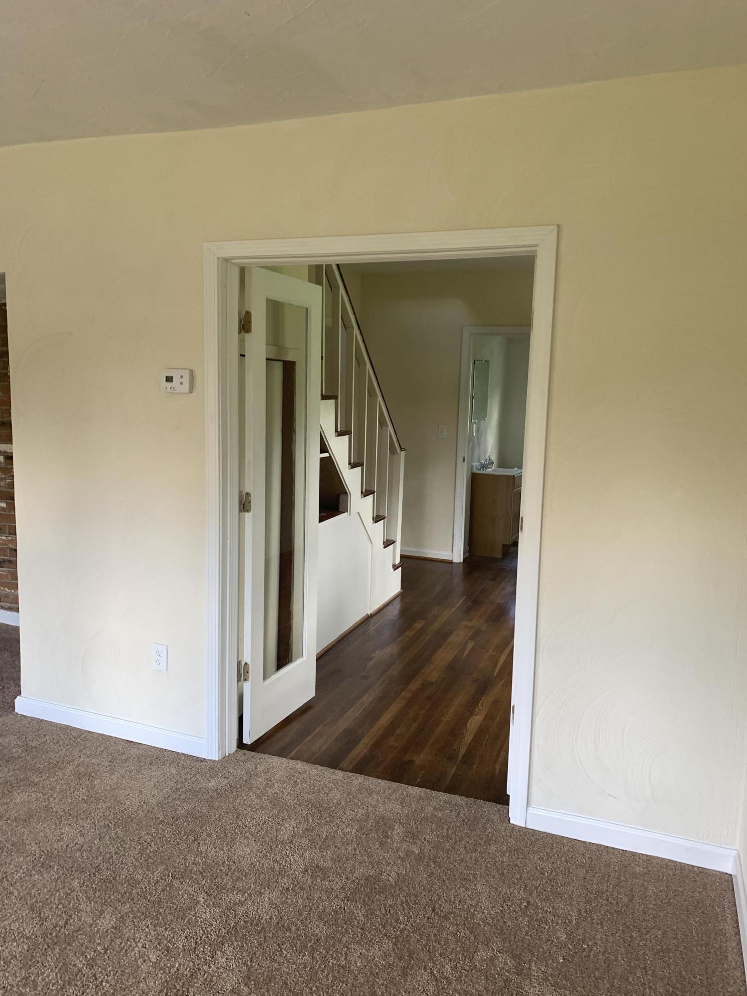 85 Old Ferrum Road Ferrum, VA 24088 - Photo 44 of 60 a view of a hallway with wooden floor and a living room