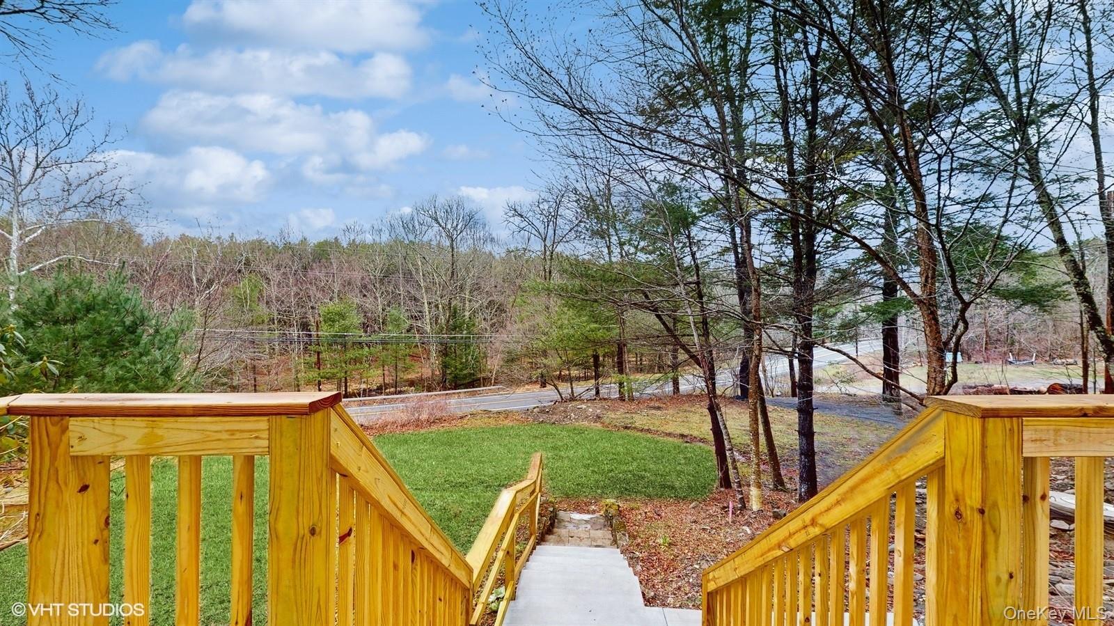 736 State Rte 55 Napanoch, NY 12458 - Photo 23 of 49 Wooden deck with a lawn and a wooded view