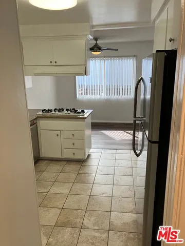 a kitchen with a sink a stove and a refrigerator