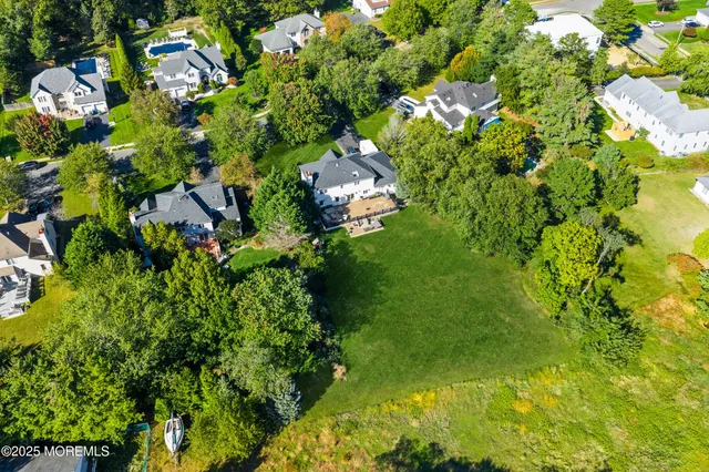 a aerial view of a house with swimming pool and garden
