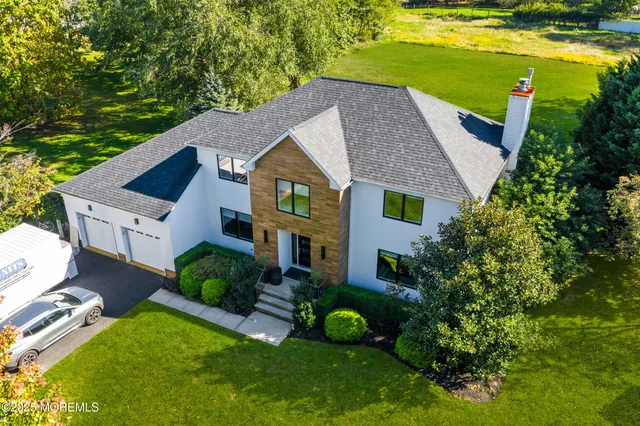 a view of a hallway with wooden floor and stairs