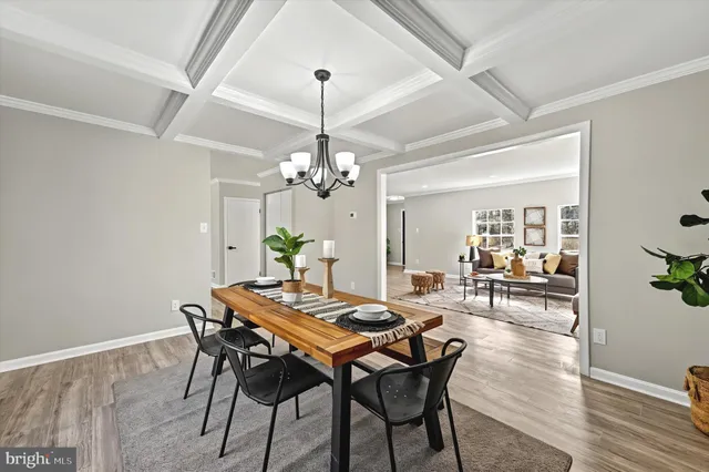 a view of a dining room with furniture wooden floor and chandelier