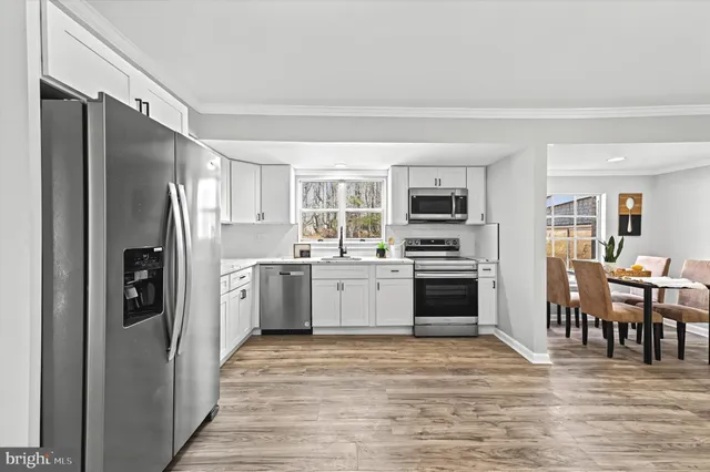 a kitchen with a refrigerator stove and microwave