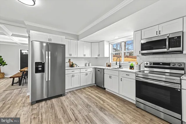a kitchen with a refrigerator stove and microwave