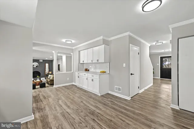 a kitchen with stainless steel appliances a refrigerator and wooden floor