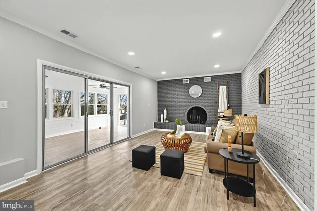 a living room with furniture a table and wooden floor