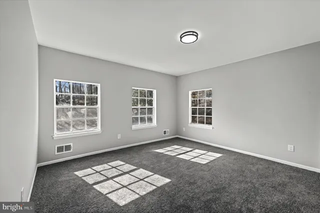 a view of a big room with windows