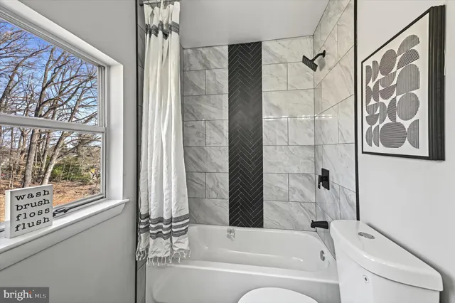 a bathroom with a bathtub and shower