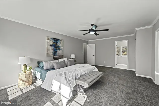 a bedroom with a bed and a ceiling fan