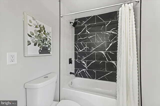 a bathroom with a shower and a toilet