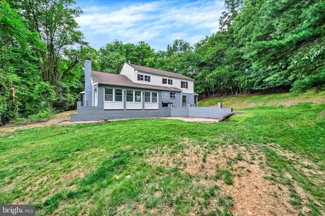 a front view of a house with a yard table and chairs