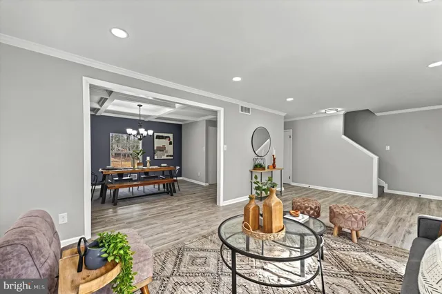 a living room with furniture and a dining table with kitchen view