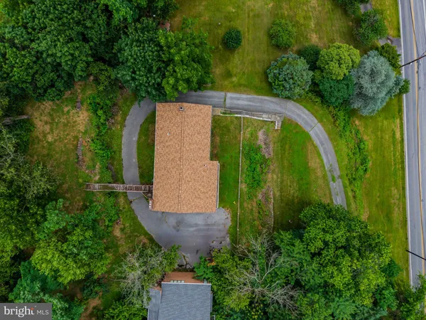 an aerial view of a house with a yard