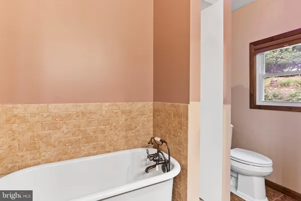 a bathroom with a bathtub and toilet