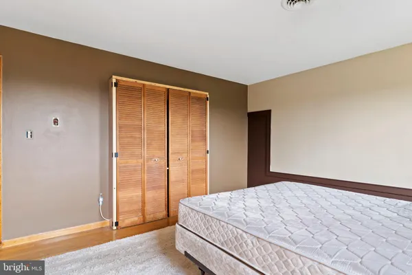 a bedroom with a bed and a mirror