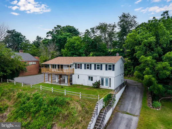 a house with green field in front of it
