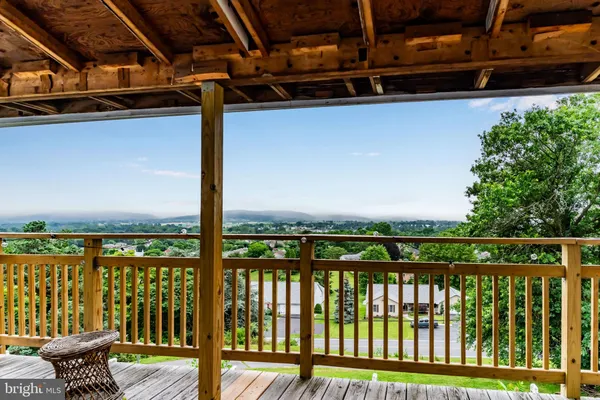 a view of a balcony with chair and wooden floor