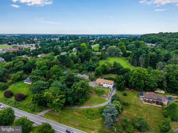 an aerial view of a house with a yard