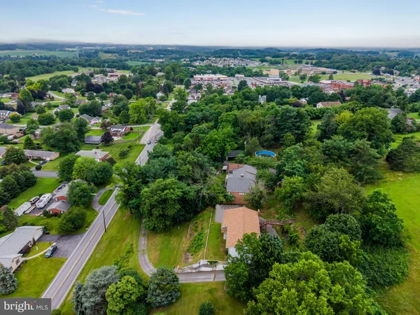 an aerial view of residential houses with outdoor space and swimming pool