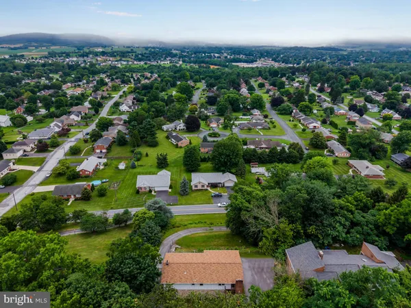 an aerial view of residential houses with outdoor space and street view