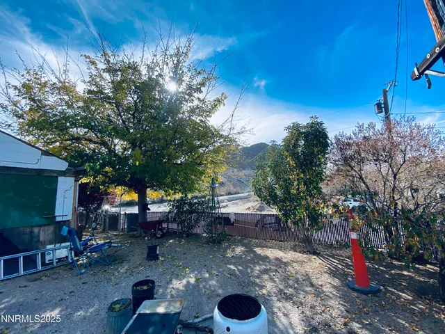 a view of a backyard with sitting area