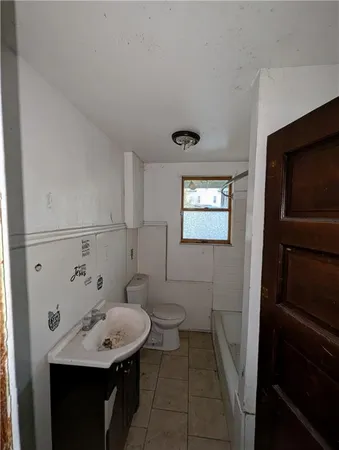 a bathroom with a sink toilet and a mirror