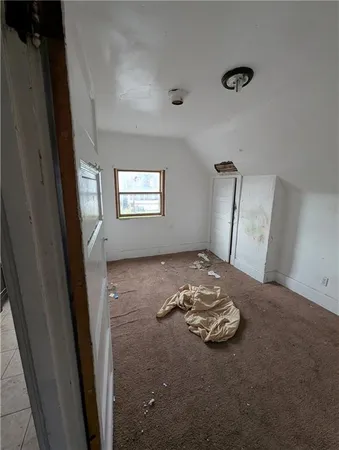 a view of a livingroom with the kitchen