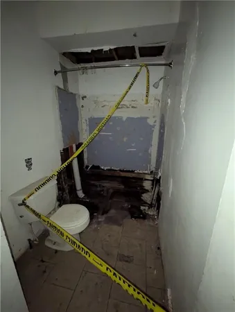 a bathroom with a sink toilet and a mirror