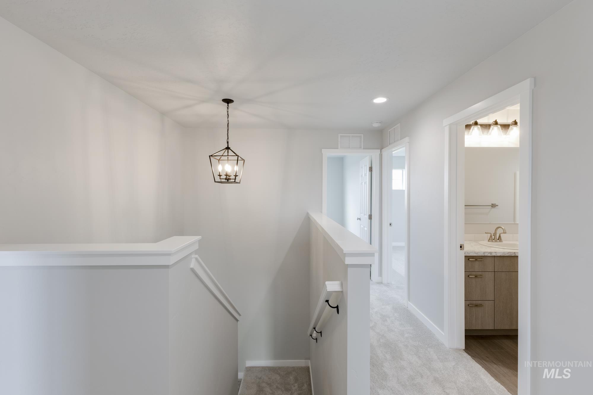 1602 Long Pond Street Middleton, ID 83644 - Photo 10 of 20 Stairway with carpet, recessed lighting, and a chandelier