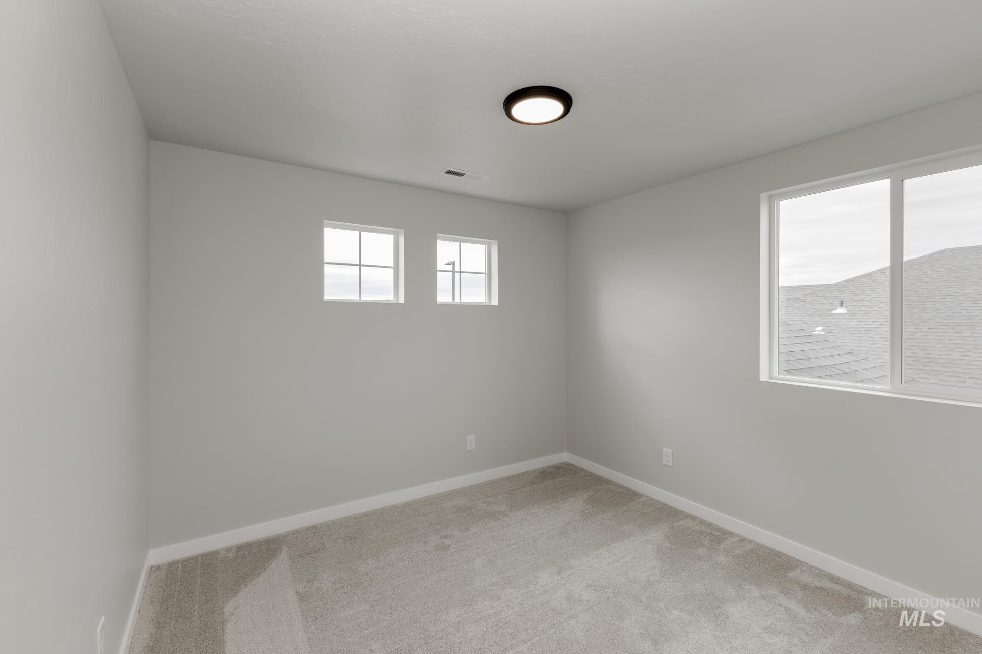 1602 Long Pond Street Middleton, ID 83644 - Photo 12 of 20 Unfurnished room featuring light colored carpet and baseboards