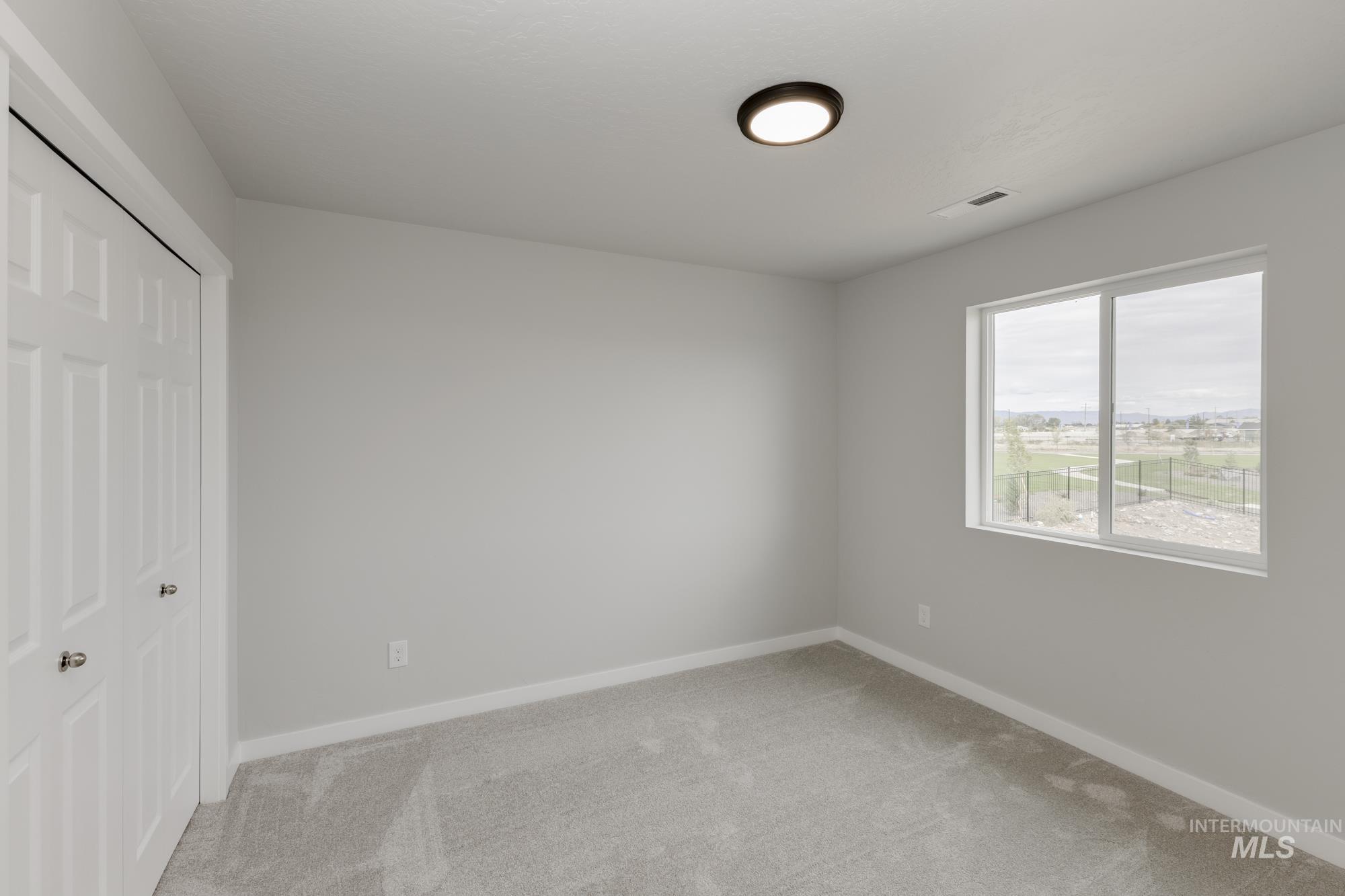 1602 Long Pond Street Middleton, ID 83644 - Photo 14 of 20 Unfurnished bedroom featuring light colored carpet and a closet