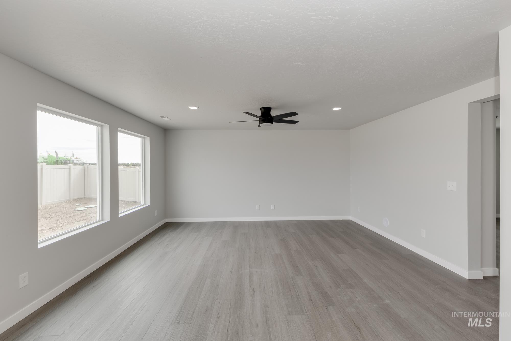 1602 Long Pond Street Middleton, ID 83644 - Photo 6 of 20 Spare room with light wood-type flooring, a ceiling fan, and recessed lighting