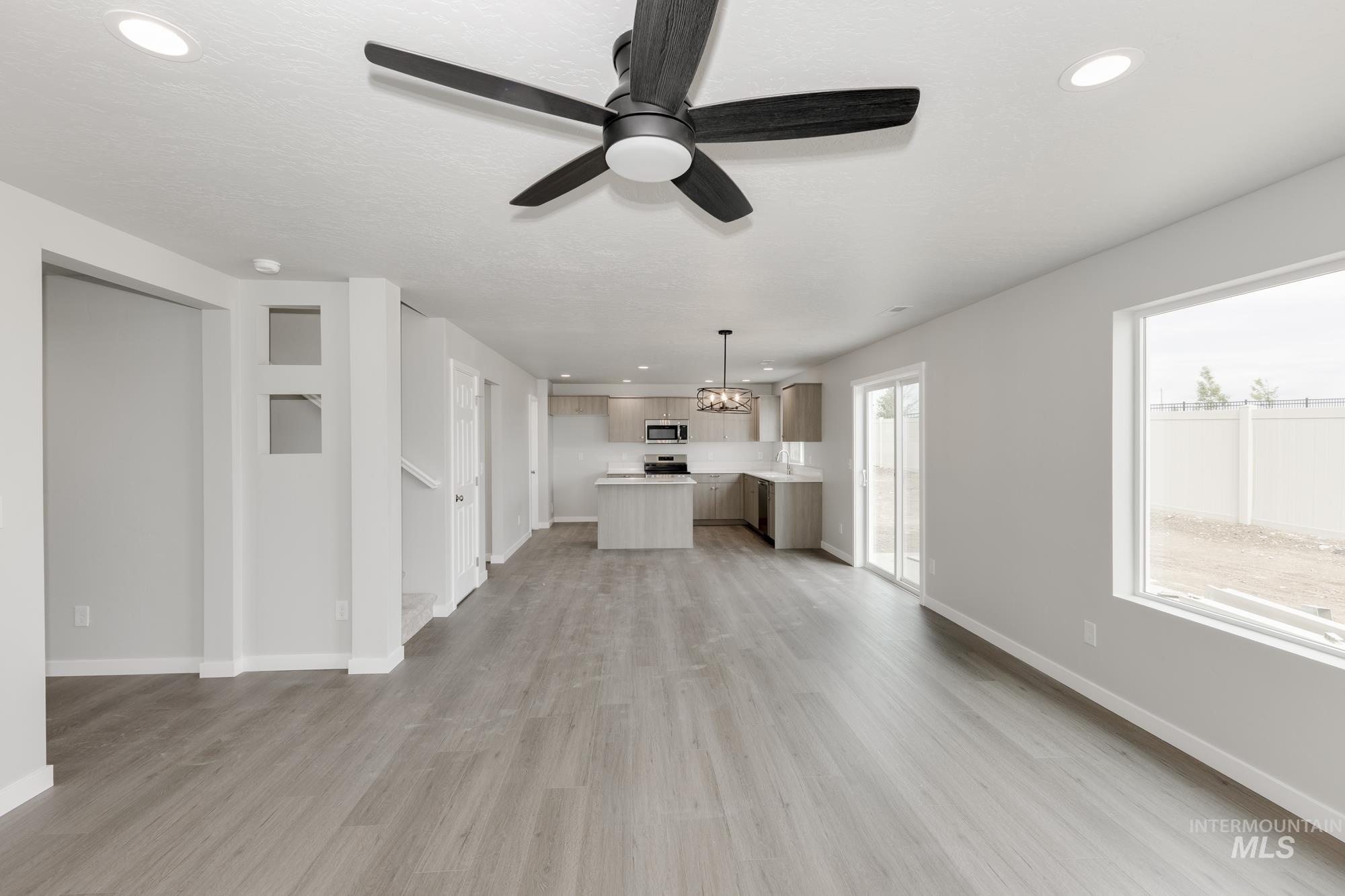 1602 Long Pond Street Middleton, ID 83644 - Photo 7 of 20 Unfurnished living room with recessed lighting, light wood-style flooring, and ceiling fan