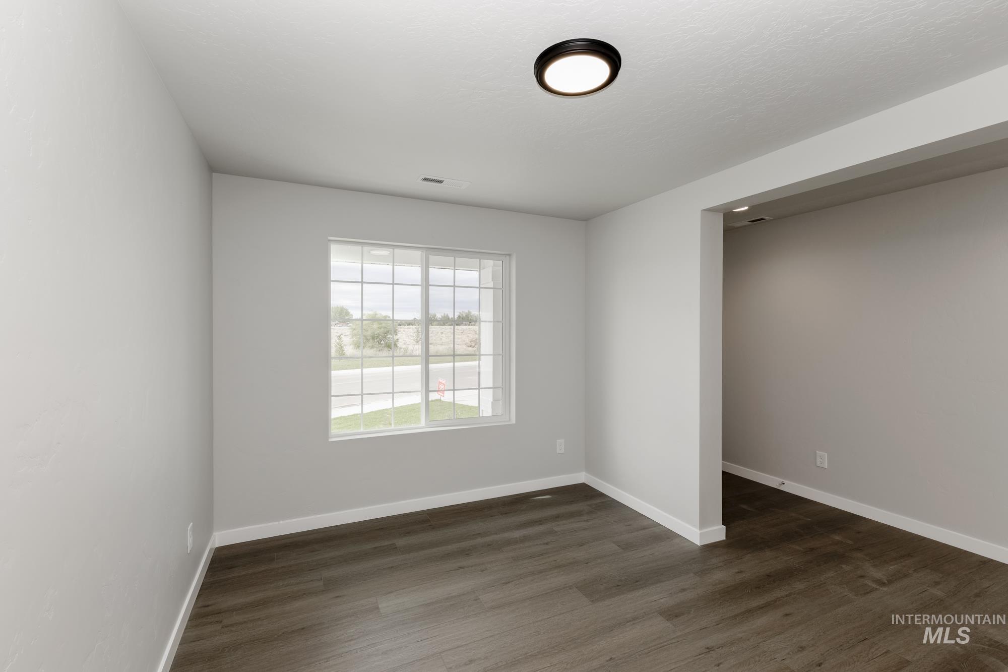 1602 Long Pond Street Middleton, ID 83644 - Photo 9 of 20 Unfurnished bedroom with dark wood finished floors and baseboards