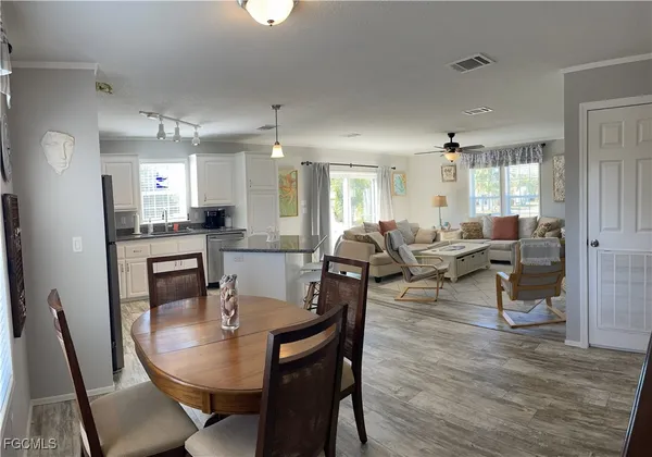 a view of a dining room with furniture and wooden floor