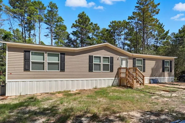 a view of a house with backyard
