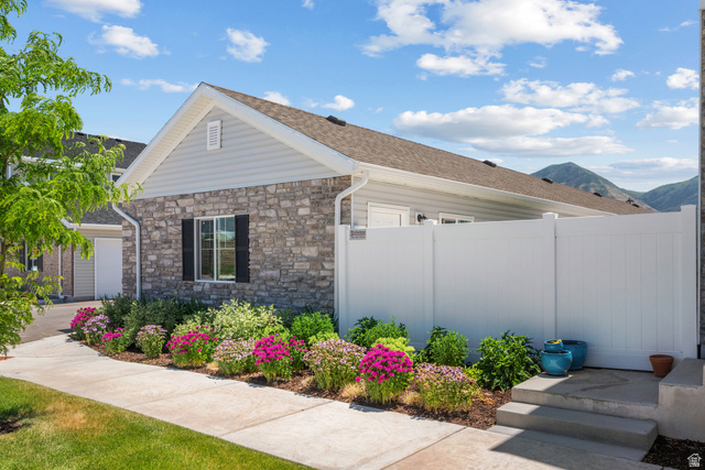 1693 North Center Point Lane Salem, UT 84653 - Photo 24 of 26 Stone and siding exterior with a pitched roof and visible mountain backdrop