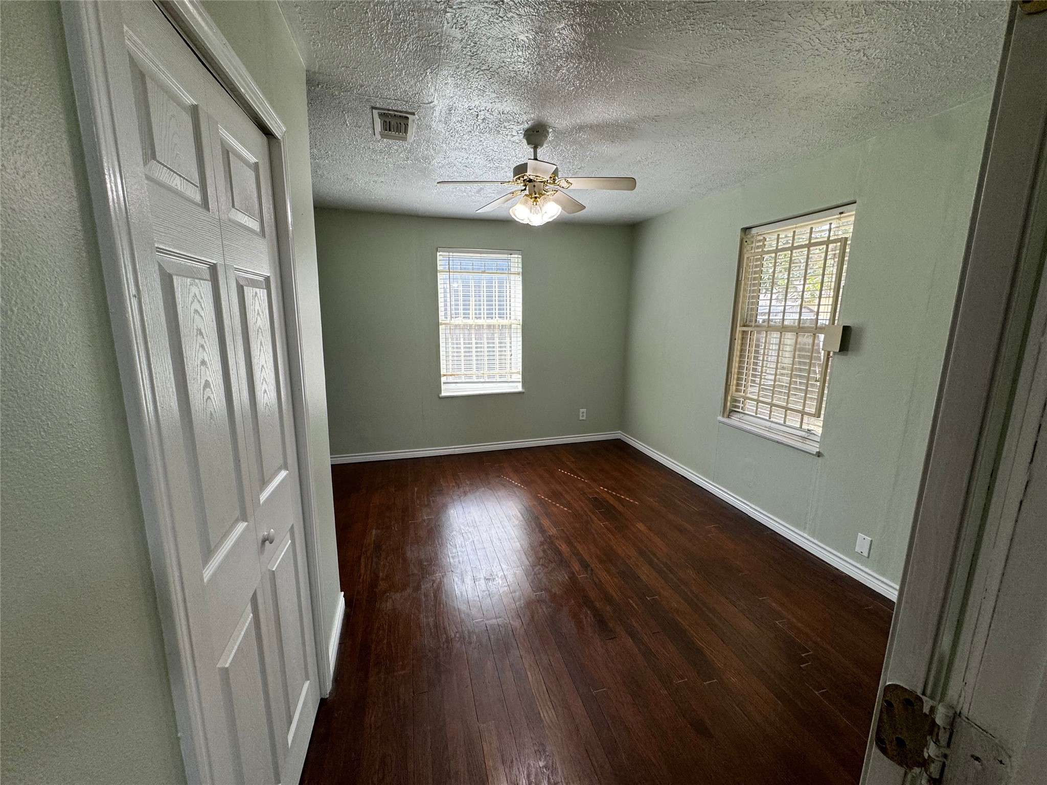 125 Pomeroy Street Pasadena, TX 77506 - Photo 13 of 19 wooden floor in an empty room with a window