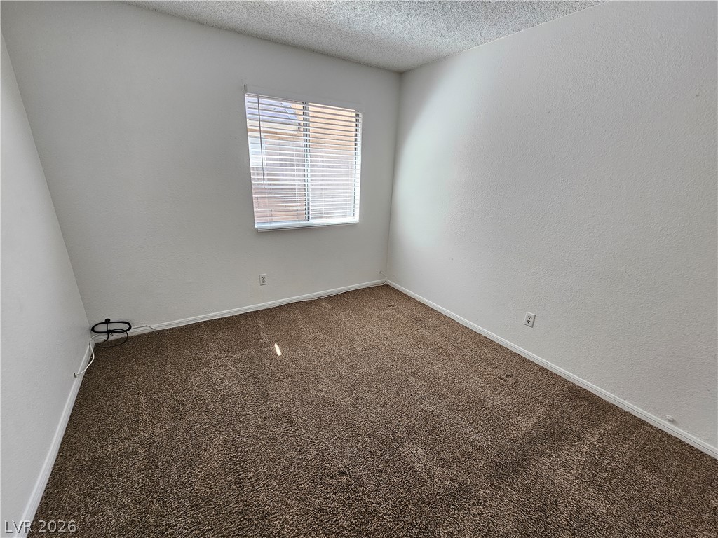 2817 Albemarle Way Henderson, NV 89014 - Photo 14 of 25 Naturally illuminated bedroom with neutral tones and comfortable carpeting.