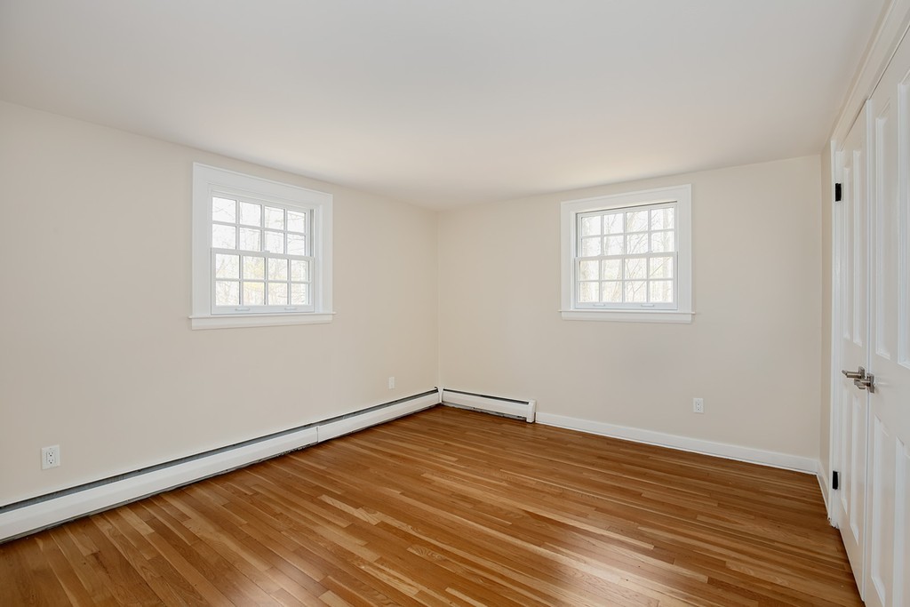 211 Pope Road Acton, MA 01742 - Photo 17 of 29 an empty room with wooden floor and windows